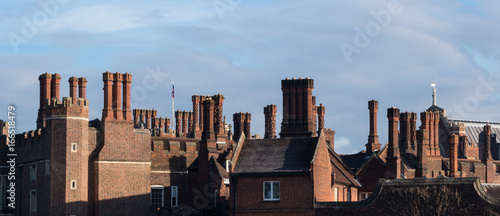 Quadro su tela Chimneys and parapets on Tudor architecture red brick building skyline