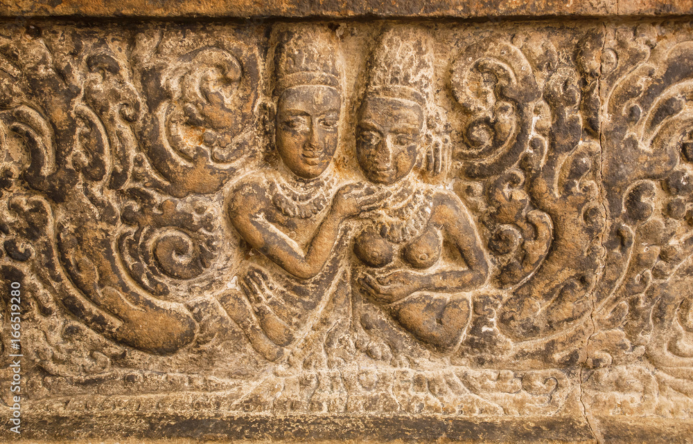 Symbol of love. Two bodies on carved wall relief made in circa 7th century. Artwork inside Hindu temple of Aihole, India