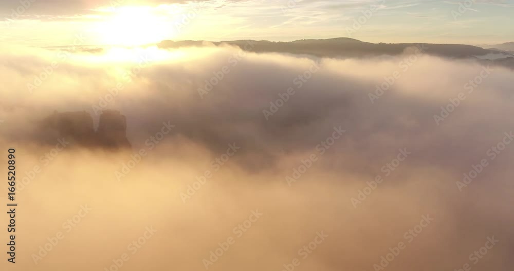 Drone flight through sunny fog and clouds, flying against sunlight in beautiful sunset with lens flare, pure nature, 4K Drone flight through sunny fog and clouds, flying against sunlight in beautiful sunset with lens flare, pure nature, 4K