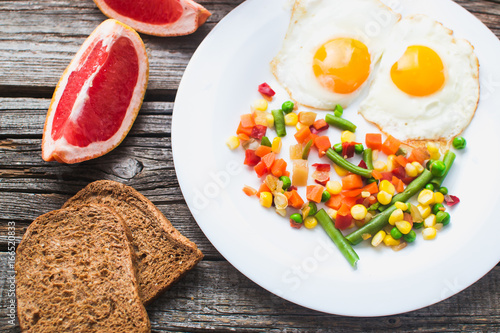 Breakfast on the wooden background from chicken breast photo