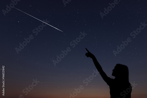 Kid makes a wish by seeing a shooting star. photo