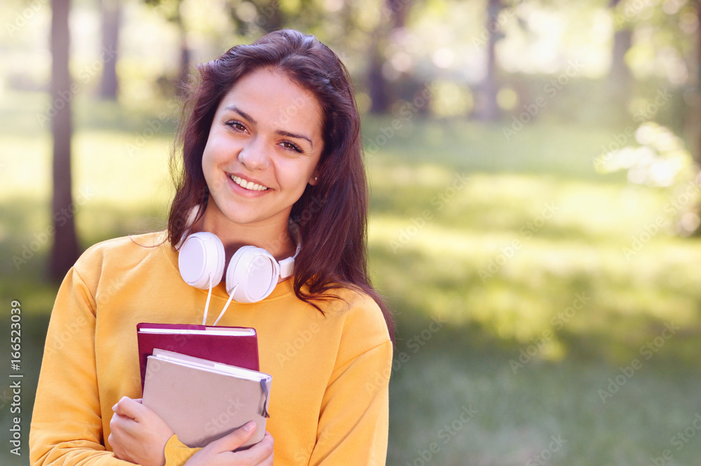 Young beautiful and trendy student girl holding books. Young beautiful and trendy student girl holding books.