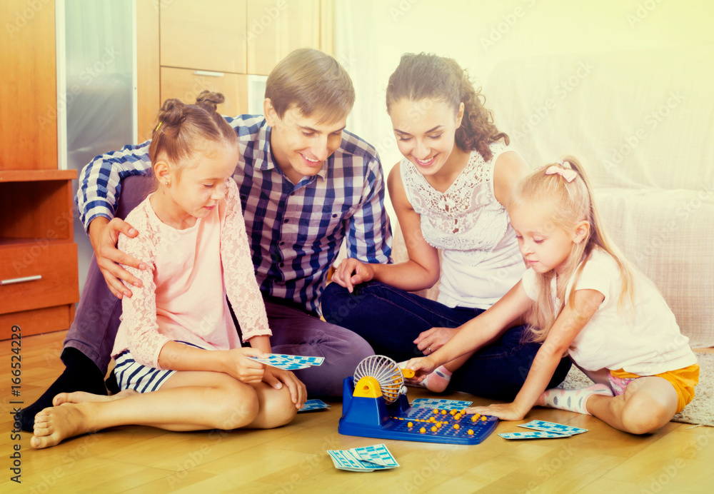 Fototapeta premium Parents and daughters with toy lotto