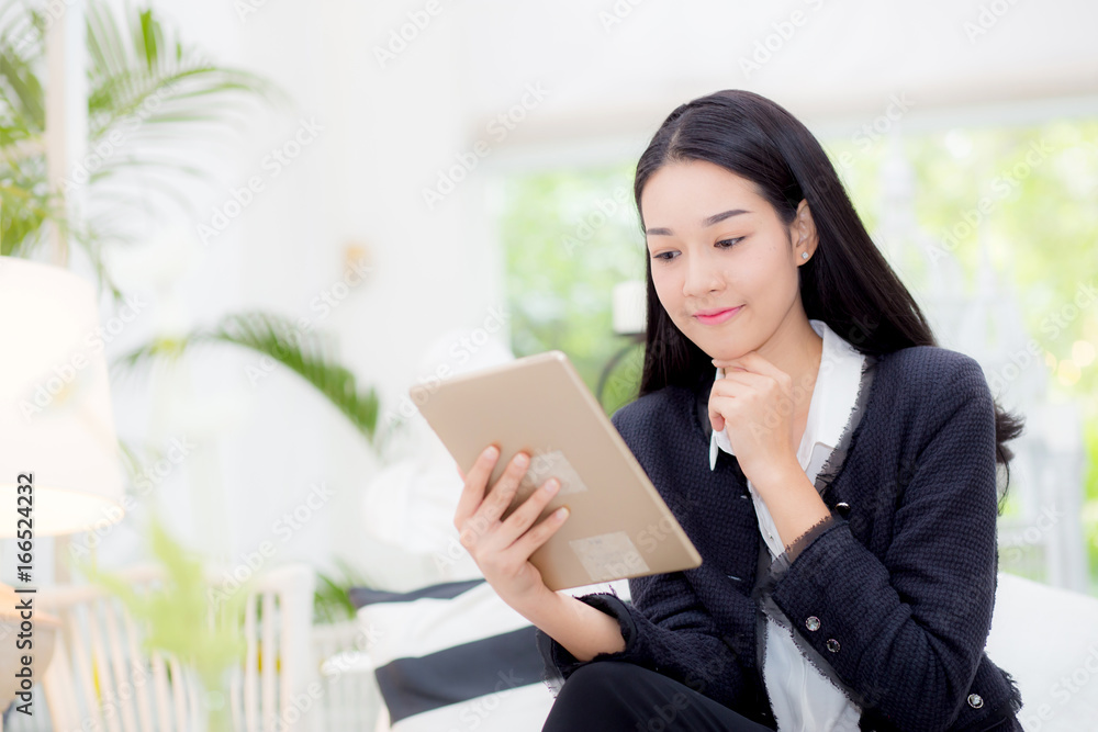 Young businesswoman asian sitting at table looking tablet, business concept. Young businesswoman asian sitting at table looking tablet, business concept.