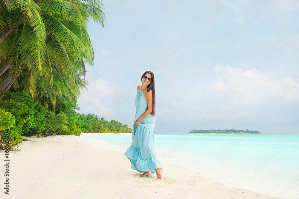 Beautiful young woman on sea beach at tropical resort Beautiful young woman on sea beach at tropical resort