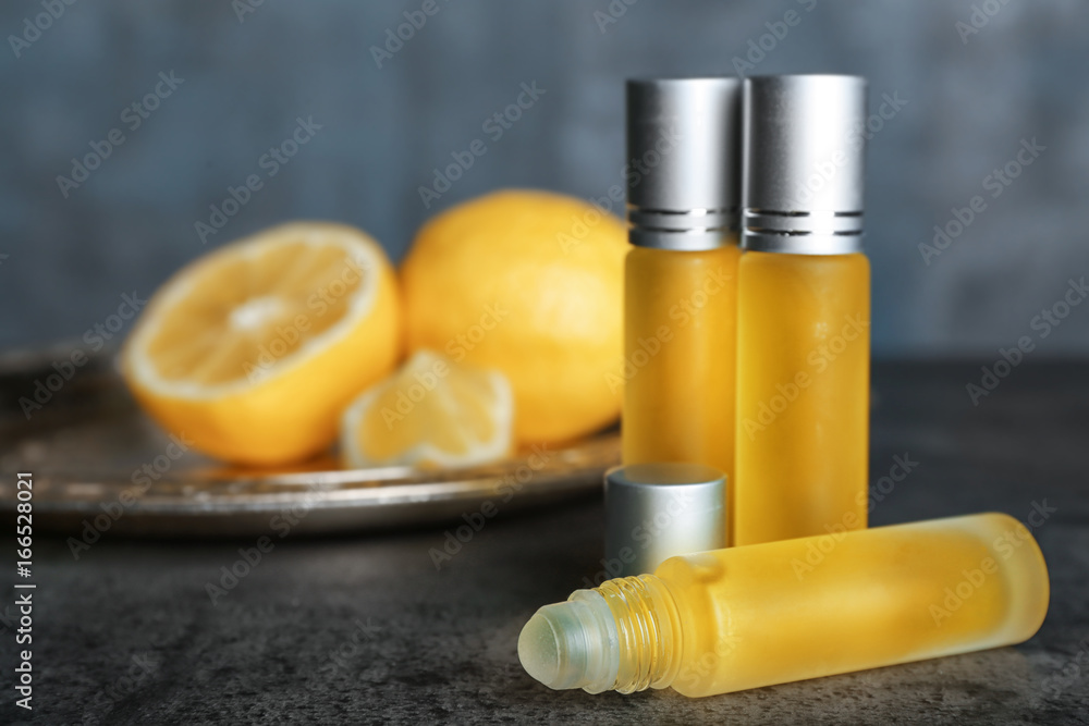 Bottles of perfume and blurred lemons on background Bottles of perfume and blurred lemons on background