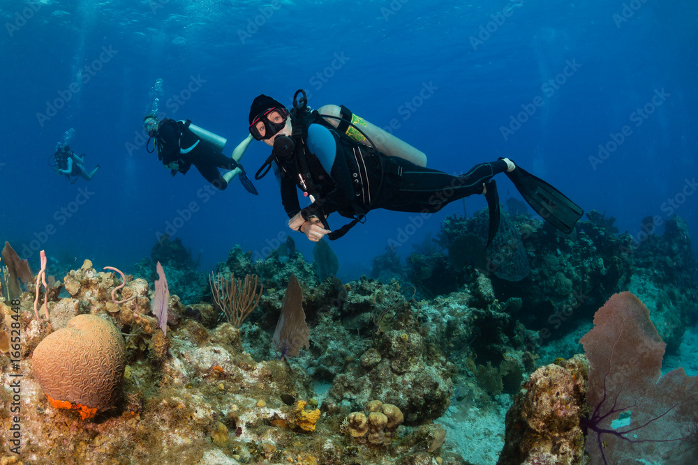 Female SCUBA diver on a tropical coral reef Female SCUBA diver on a tropical coral reef