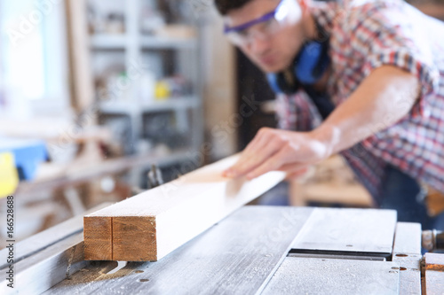 Young carpenter working wit...