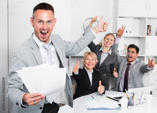 Happy business group with smiling man at office photo