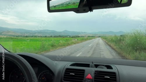 Driving a car on rural road on rainy  photo