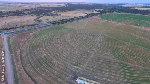 Aerial footage of circle crop irrigation along River Murray on hay crop photo