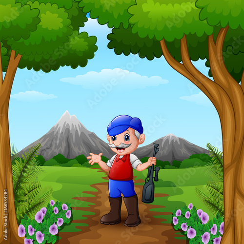 Hunter man holding his gun in the jungle