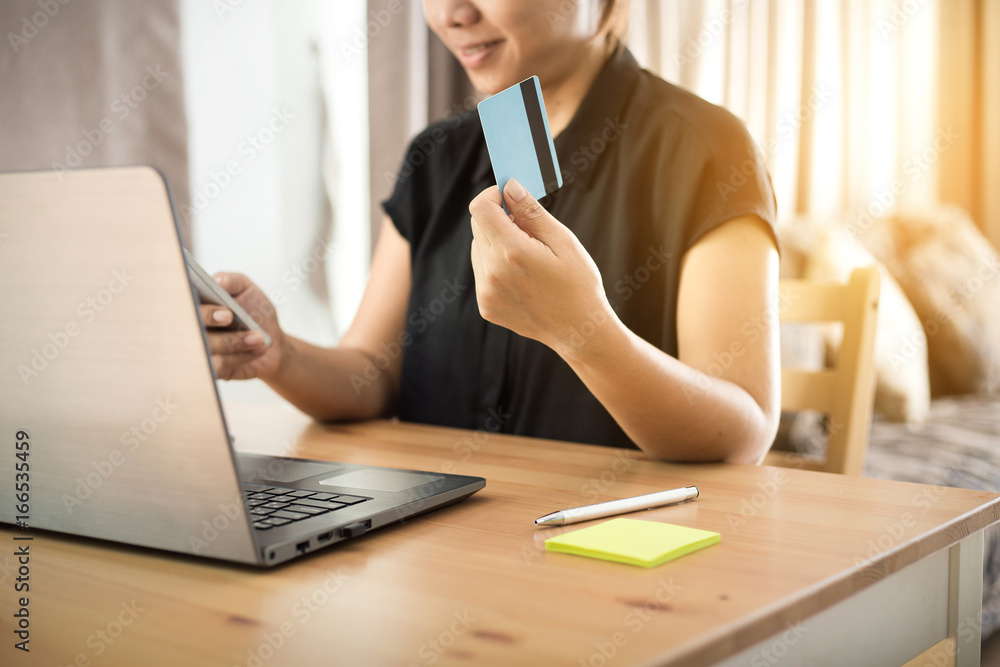 shopping online concept. Young woman holding credit card and mobile smart phone shopping online concept. Young woman holding credit card and mobile smart phone