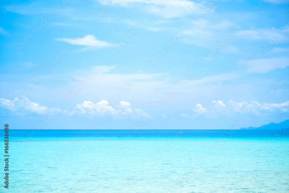Beautiful white clouds on blue sky over calm sea with sunlight reflection, Tranquil sea harmony of calm water surface. Vibrant sea with clouds on horizon Beautiful white clouds on blue sky over calm sea with sunlight reflection, Tranquil sea harmony of calm water surface. Vibrant sea with clouds on horizon