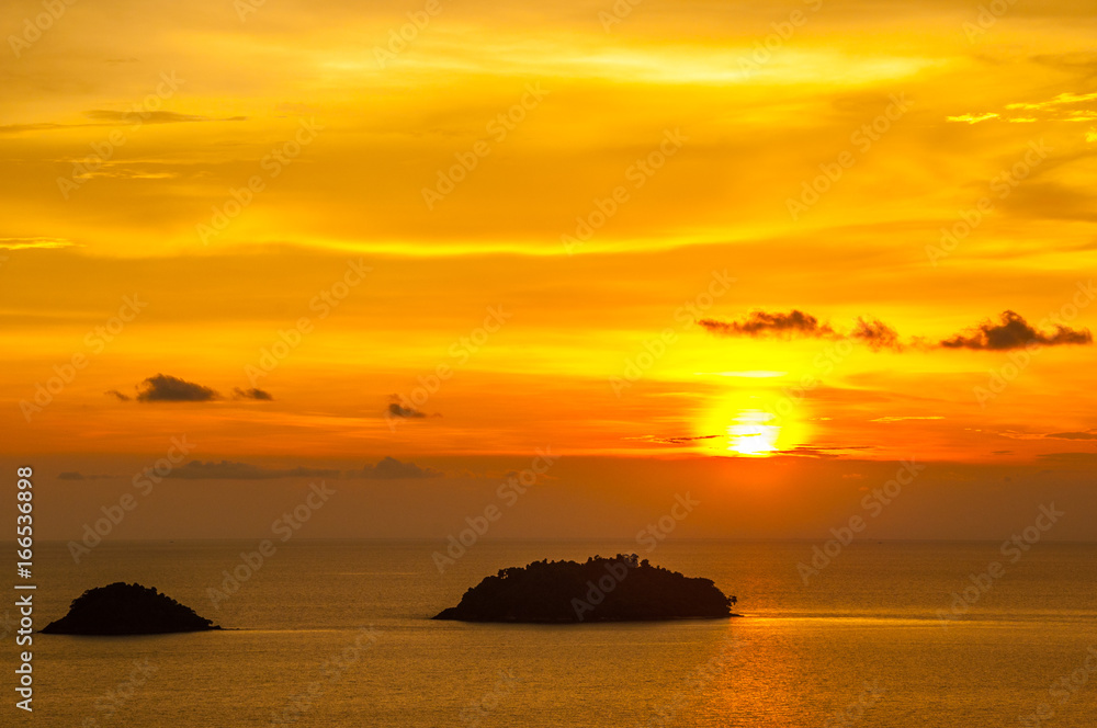 Beautiful blazing sunset landscape at black sea and orange sky above it. Amazing summer sunset view on the beach.