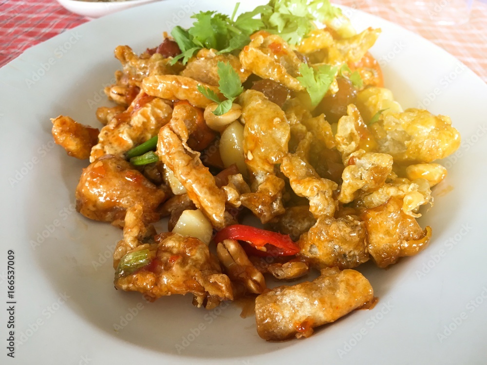 spicy crispy dried fish maw and peanut on dish spicy crispy dried fish maw and peanut on dish