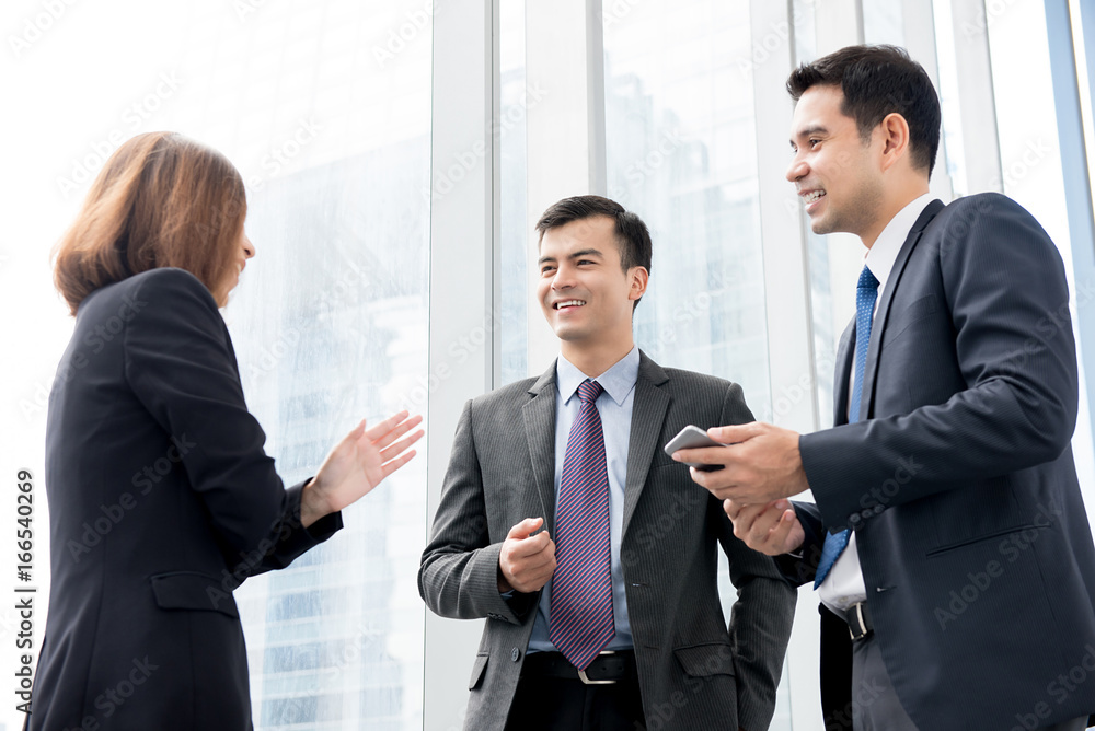 Group of business people talking at building hallway in the office Group of business people talking at building hallway in the office