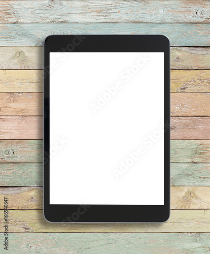 Black tablet pc on old wood...