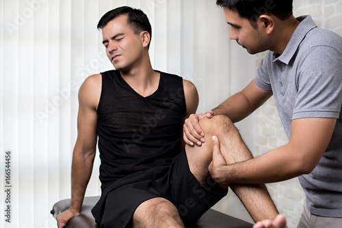 Physiotherapist treating athlete male patient