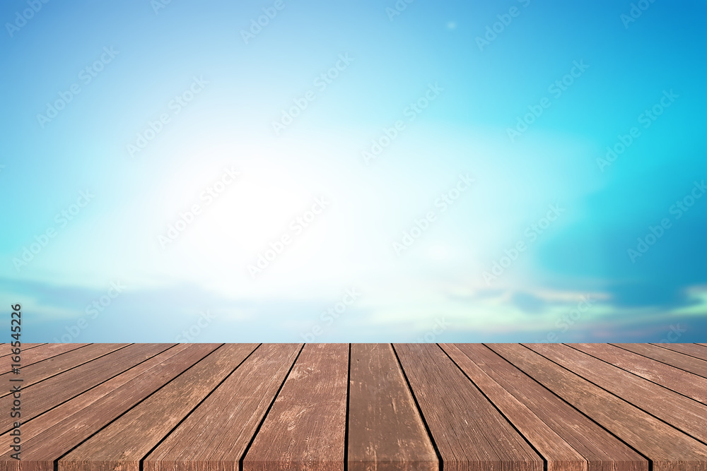 Abstract blurred beautiful glowing light of blue sky with table top wood for show or advertising products on display
