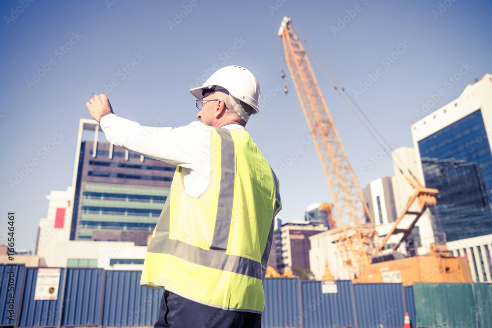 Senior foreman in glasses doing his job at building area on sunn Senior foreman in glasses doing his job at building area on sunn
