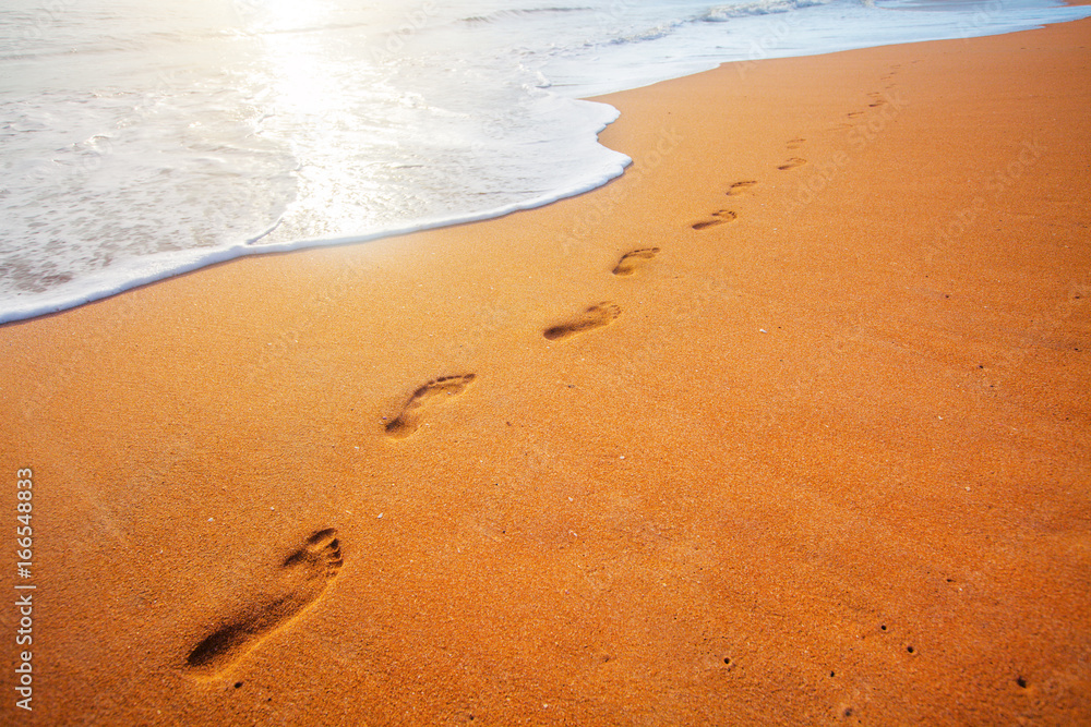 beach, wave and footprints at sunset time beach, wave and footprints at sunset time