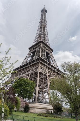 Fototapeta Naklejka Na Ścianę i Meble -  Paris, France - April 29, 2016: the Eiffel Tower. Constructed from 1887–89 as the entrance to the 1889 World's Fair, it is a wrought iron lattice tower on the Champ de Mars in Paris