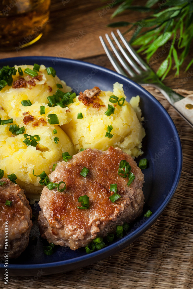 Meatballs served with boiled potatoes on a plate. Meatballs served with boiled potatoes on a plate.