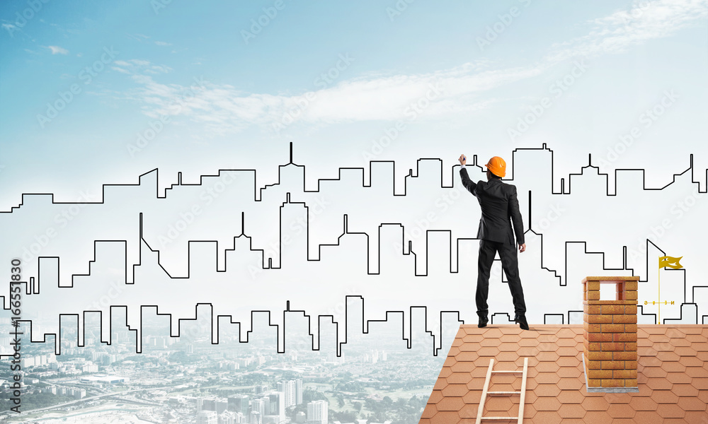 Man architect draw silhouette of modern city on blue sky. Mixed media Man architect draw silhouette of modern city on blue sky. Mixed media