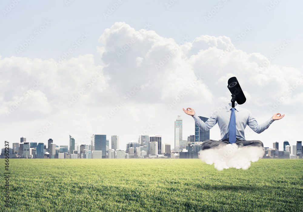 Obraz premium Camera headed man sitting in lotus pose on cloud against modern 