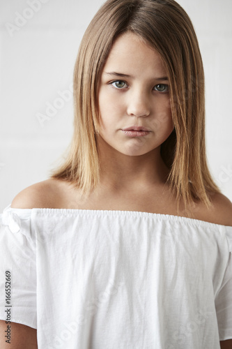 Portrait Of Stylish Young Girl Posing In Studio Against White