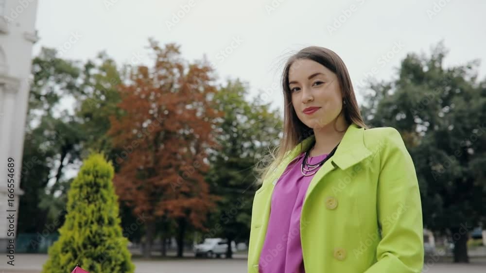 Serious woman under pink umbrella in autumn park outdoor Serious woman under pink umbrella in autumn park outdoor