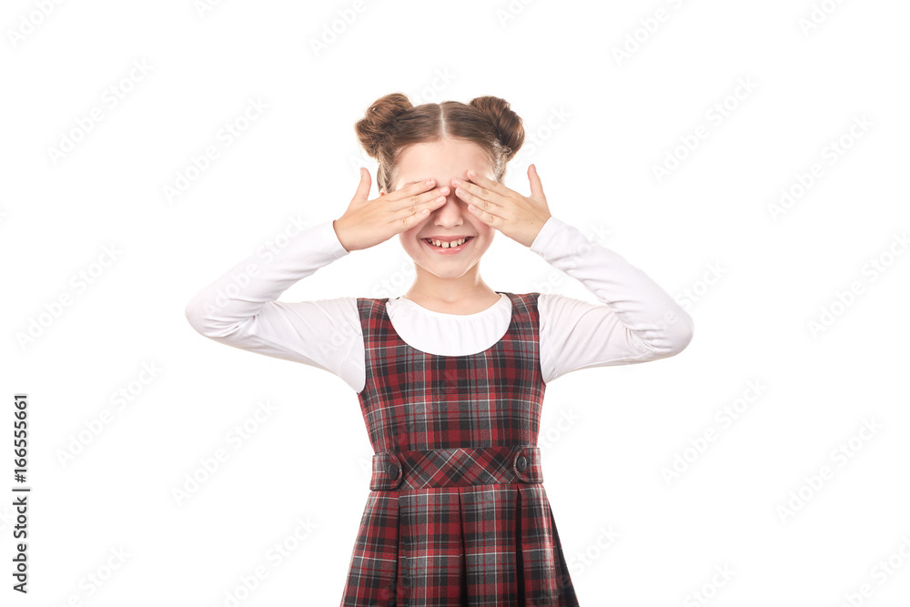 Portrait of cute girl in school uniform covering her eyes with hands against white background Portrait of cute girl in school uniform covering her eyes with hands against white background