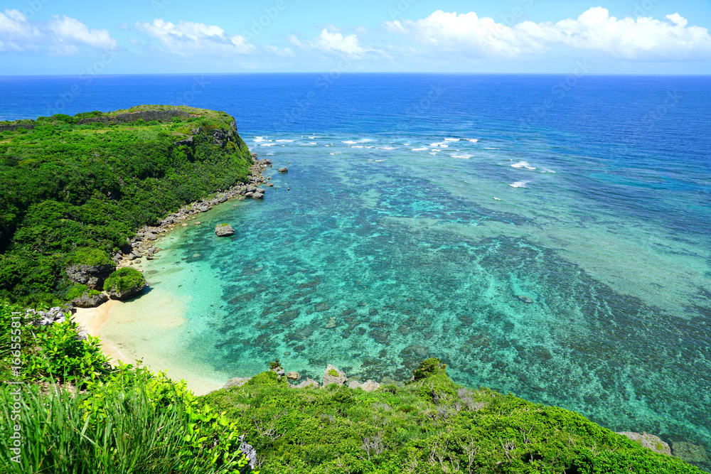 Landscape view of the Happy Cliff (Kafu Banta) overlooking the azure sea and a golden beach in Uruma, Okinawa, Japan Landscape view of the Happy Cliff (Kafu Banta) overlooking the azure sea and a golden beach in Uruma, Okinawa, Japan