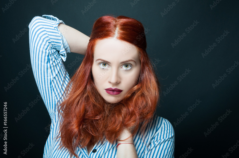 Fototapeta premium Beautiful and confident woman with long red hair