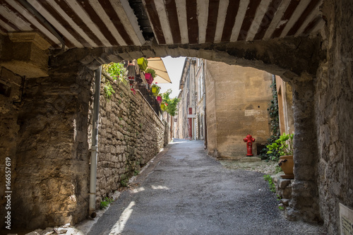 Narrow street with ancient houses at beautiful little village Bonnieux in Provence  France