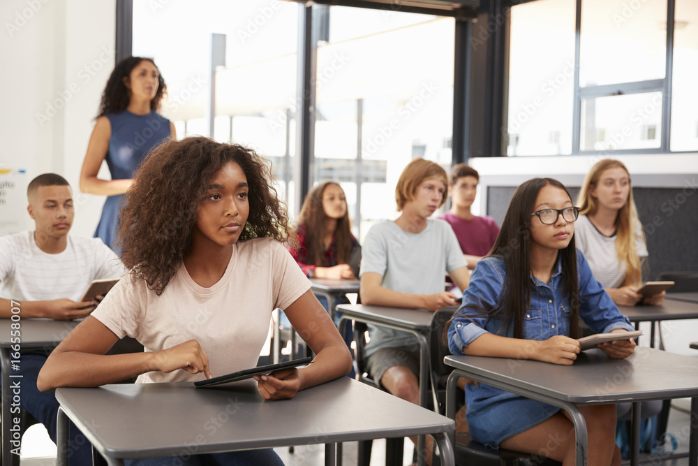 Teacher stands at the back of her high school class Teacher stands at the back of her high school class