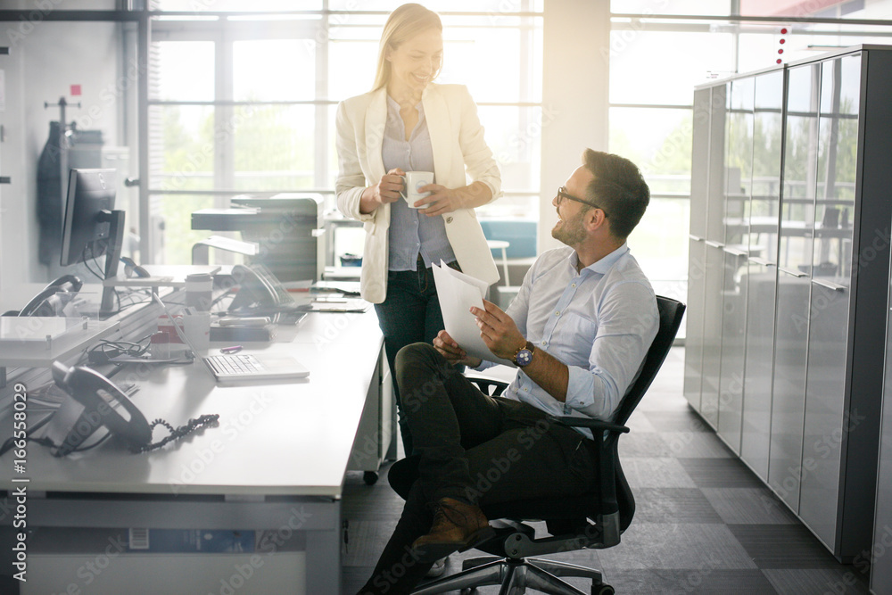 Two business people having funny conversation. Business man holding document. Two business people having funny conversation. Business man holding document.