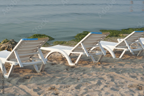 Three sunbeds in row on the beach