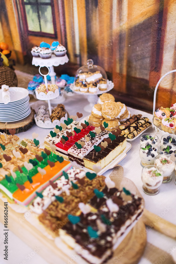 Candy bar on wedding ceremony with a lot of different candies and beverages