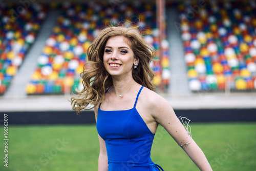 Happy young woman on stadium laughing