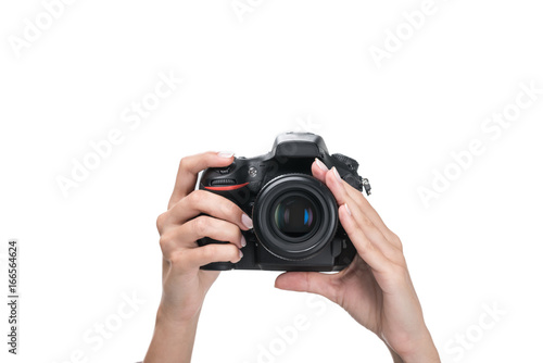 cropped view of female hands taking photo on professional camera, isolated on white