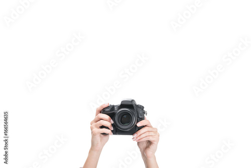 cropped view of female hands taking photo on professional camera, isolated on white