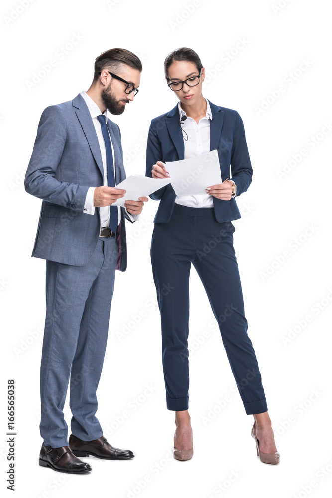 two concentrated businesspeople in suits looking at papers, isolated on white two concentrated businesspeople in suits looking at papers, isolated on white