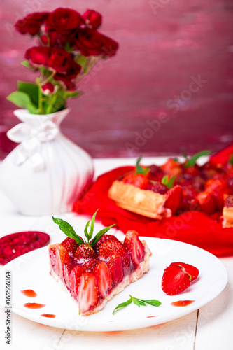 Strawberry pie on white plate and white wooden table. One piece. Romantic. Love. Heart.