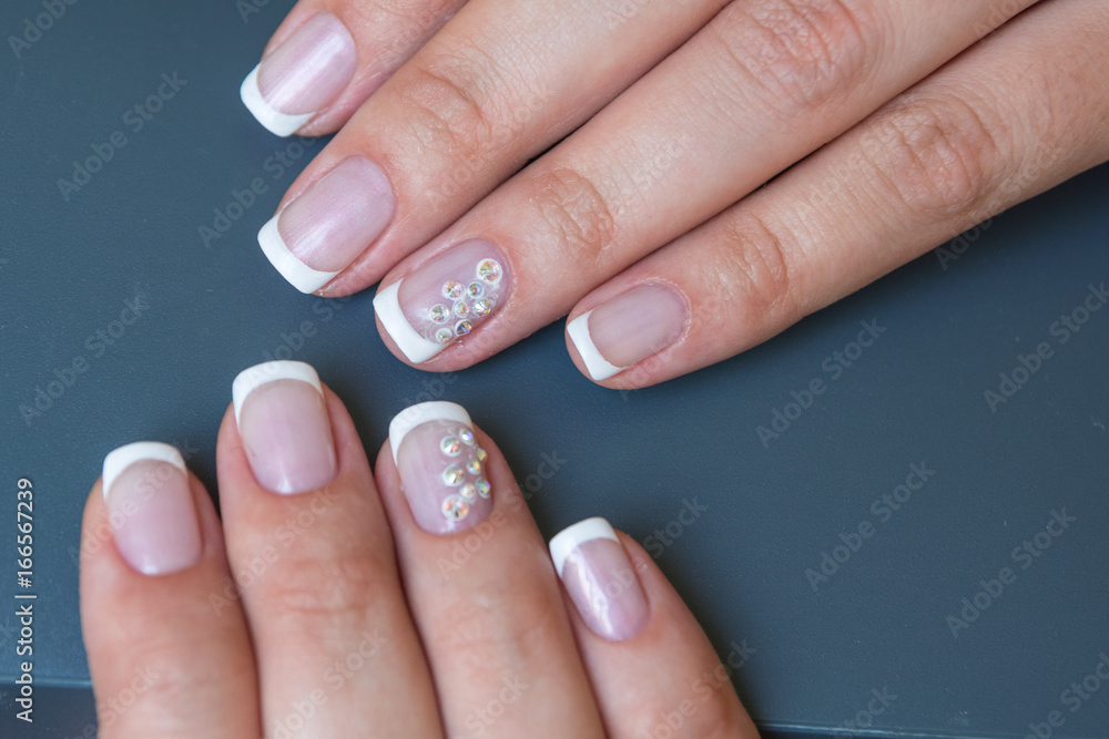 Lacquer on the nails of the hands. Fresh French manicure Lacquer on the nails of the hands. Fresh French manicure