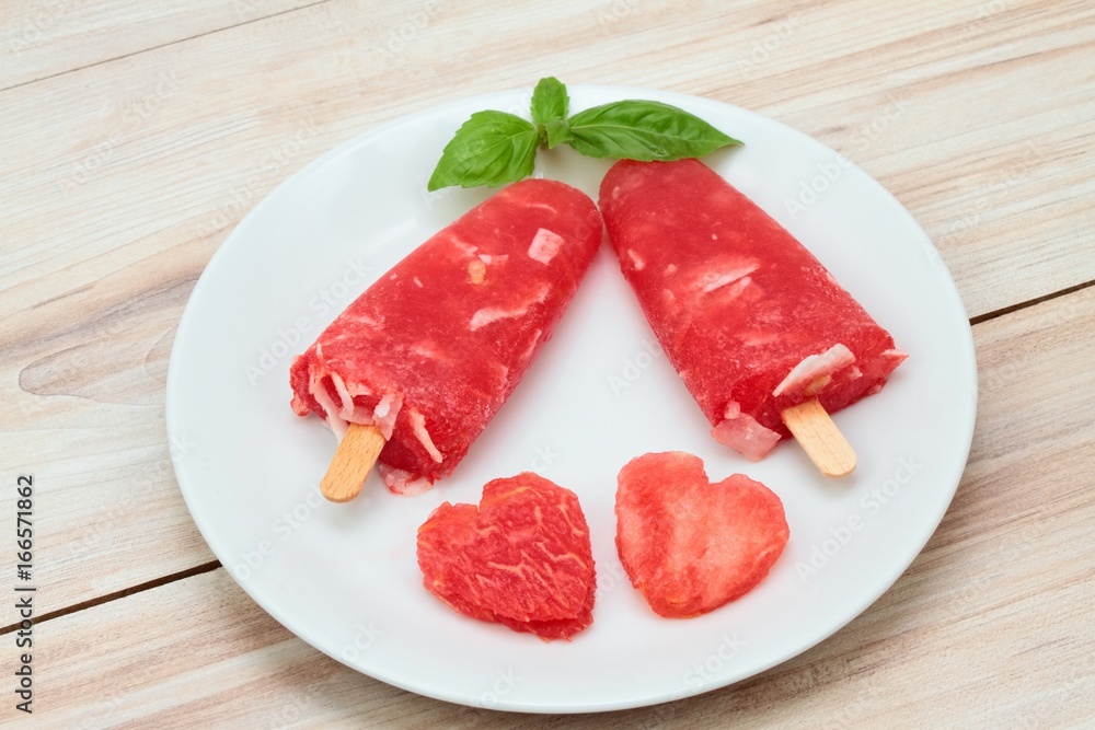 Homemade ice lolly from water melon & almond pieces Homemade ice lolly from water melon & almond pieces