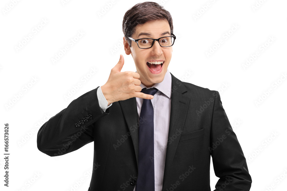 Cheerful businessman making a call me gesture Cheerful businessman making a call me gesture