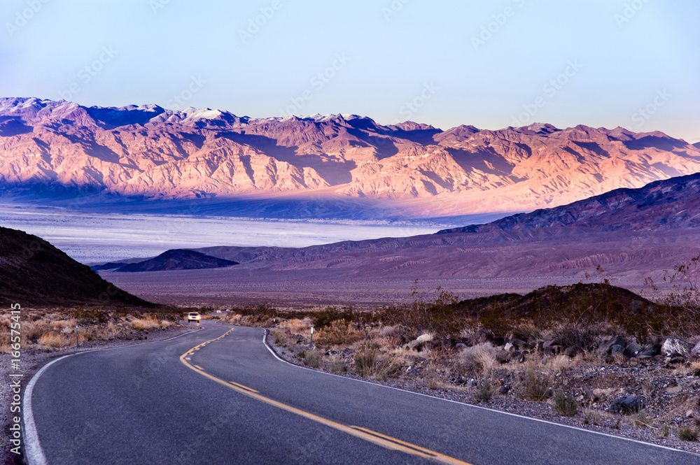 Desert road in Death Valley with mountain background