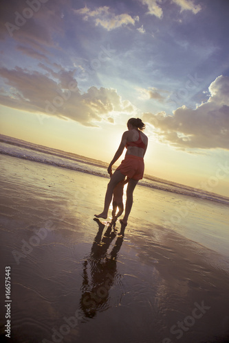 Mother with baby at Pacific Ocean Sunset